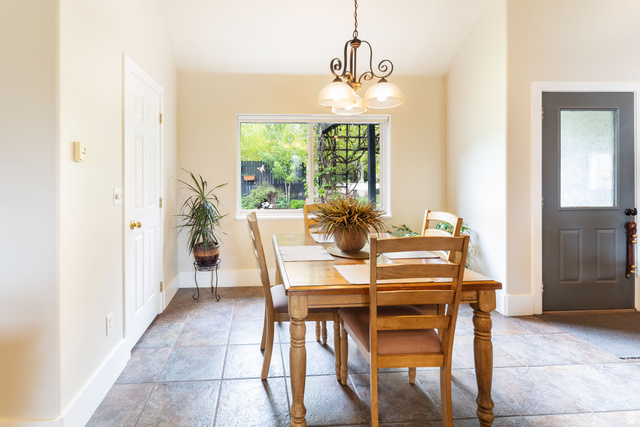 7343 North Sawtooth Cv Road Vernal, UT 84078 - Photo 12 of 64 Dining area featuring a central window, warm neutral wall tones, and tiled flooring