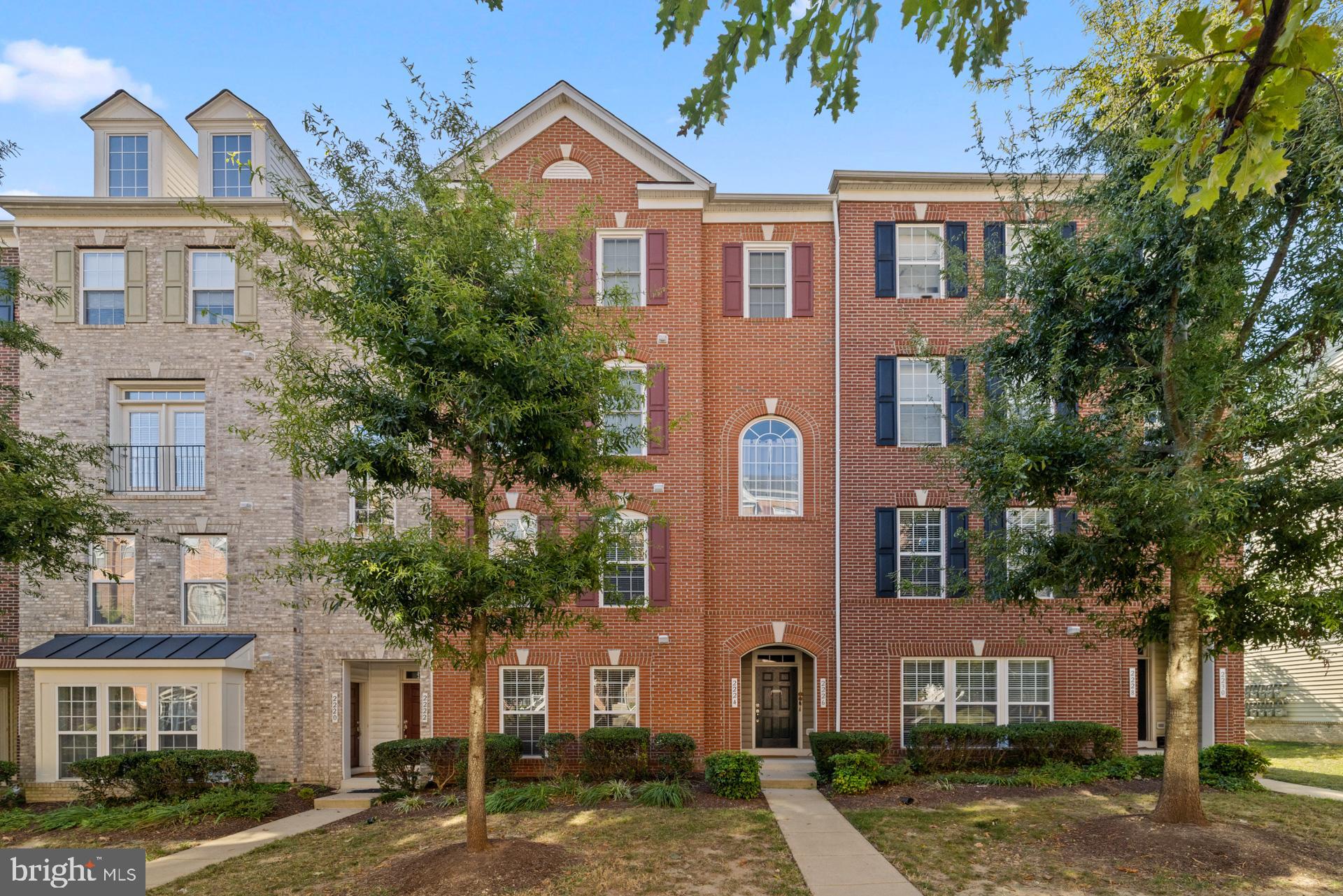 a front view of a residential apartment building with a yard