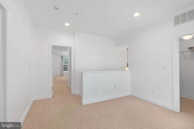 an empty room with closet and wooden door