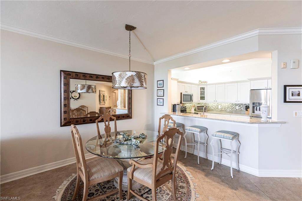 451 Bayfront Place, Unit 5309 Naples, FL 34102 - Photo 16 of 33 Dining room featuring crown molding, light tile patterned floors, and recessed lighting