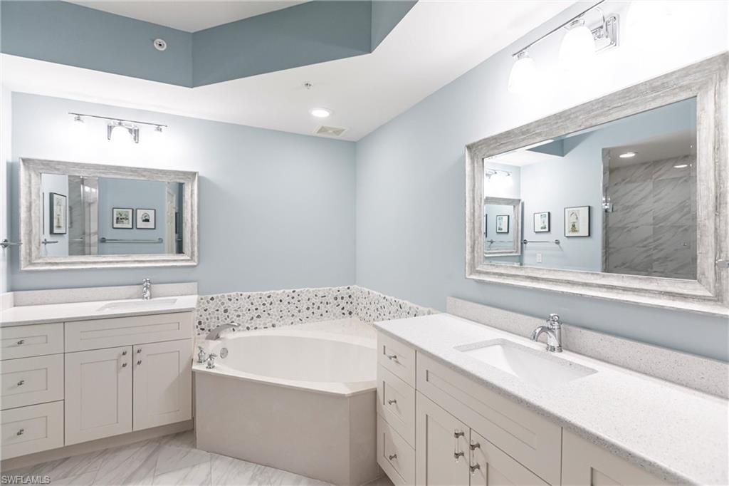 451 Bayfront Place, Unit 5309 Naples, FL 34102 - Photo 20 of 33 Full bathroom featuring light marble finish floors, a bath, two vanities, a tile shower, and recessed lighting
