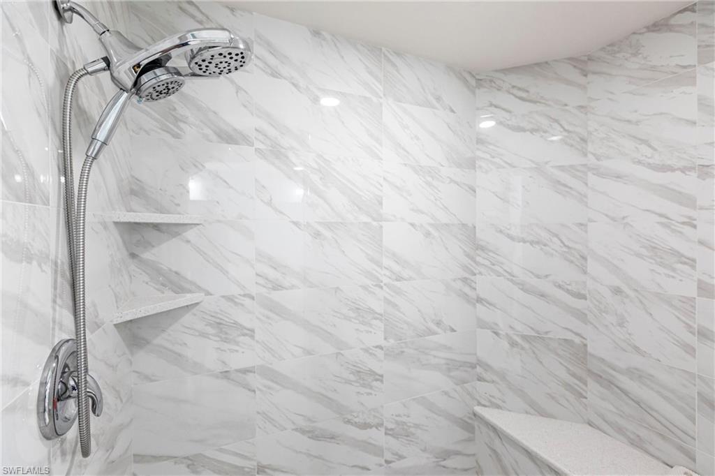 451 Bayfront Place, Unit 5309 Naples, FL 34102 - Photo 21 of 33 Bathroom featuring a marble finish shower