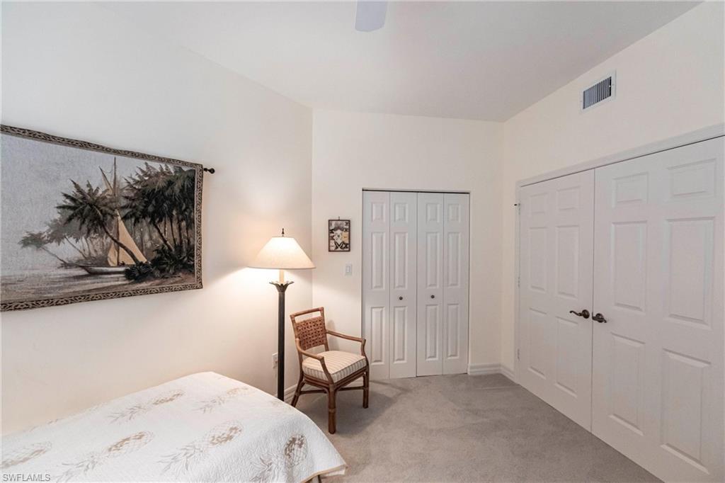 451 Bayfront Place, Unit 5309 Naples, FL 34102 - Photo 26 of 33 Bedroom featuring light colored carpet, ceiling fan, and multiple closets
