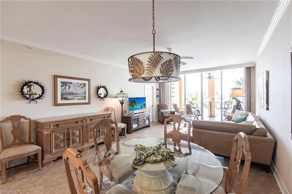 451 Bayfront Place, Unit 5309 Naples, FL 34102 - Photo 6 of 33 Dining space featuring expansive windows, ornamental molding, light tile patterned flooring, and ceiling fan