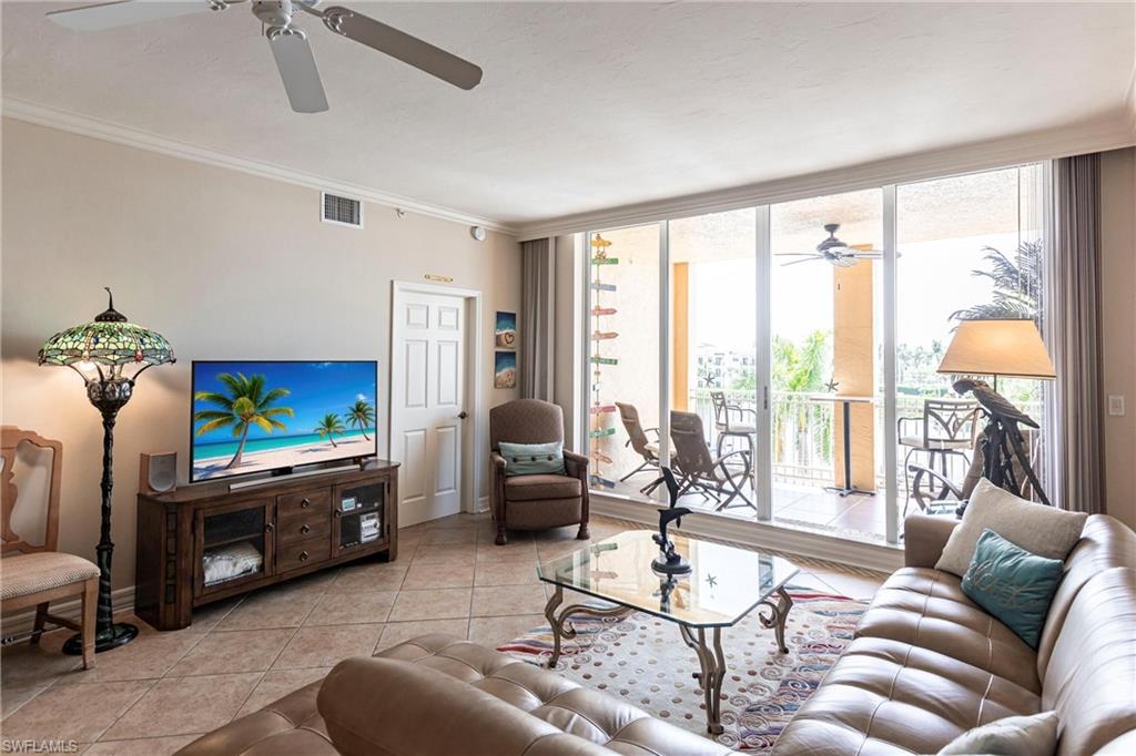 451 Bayfront Place, Unit 5309 Naples, FL 34102 - Photo 8 of 33 Tiled living area with a ceiling fan, floor to ceiling windows, and crown molding