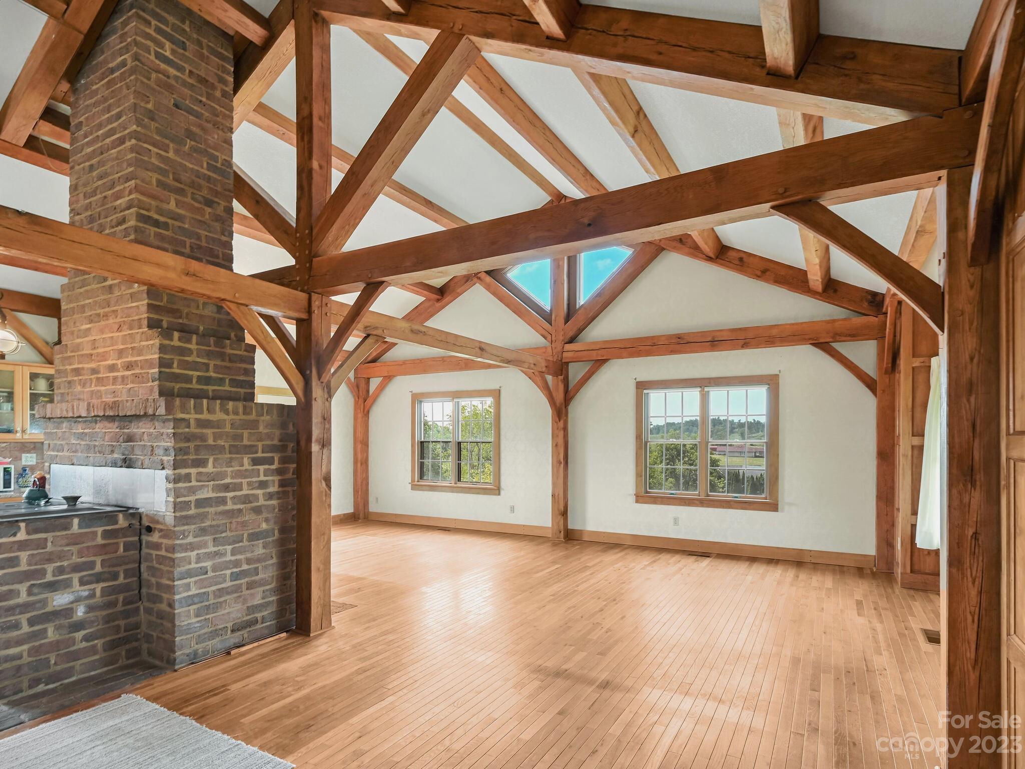 386 Heather Downs Drive Alexander, NC 28701 - Photo 12 of 29 a view of an empty room with a window and wooden floor