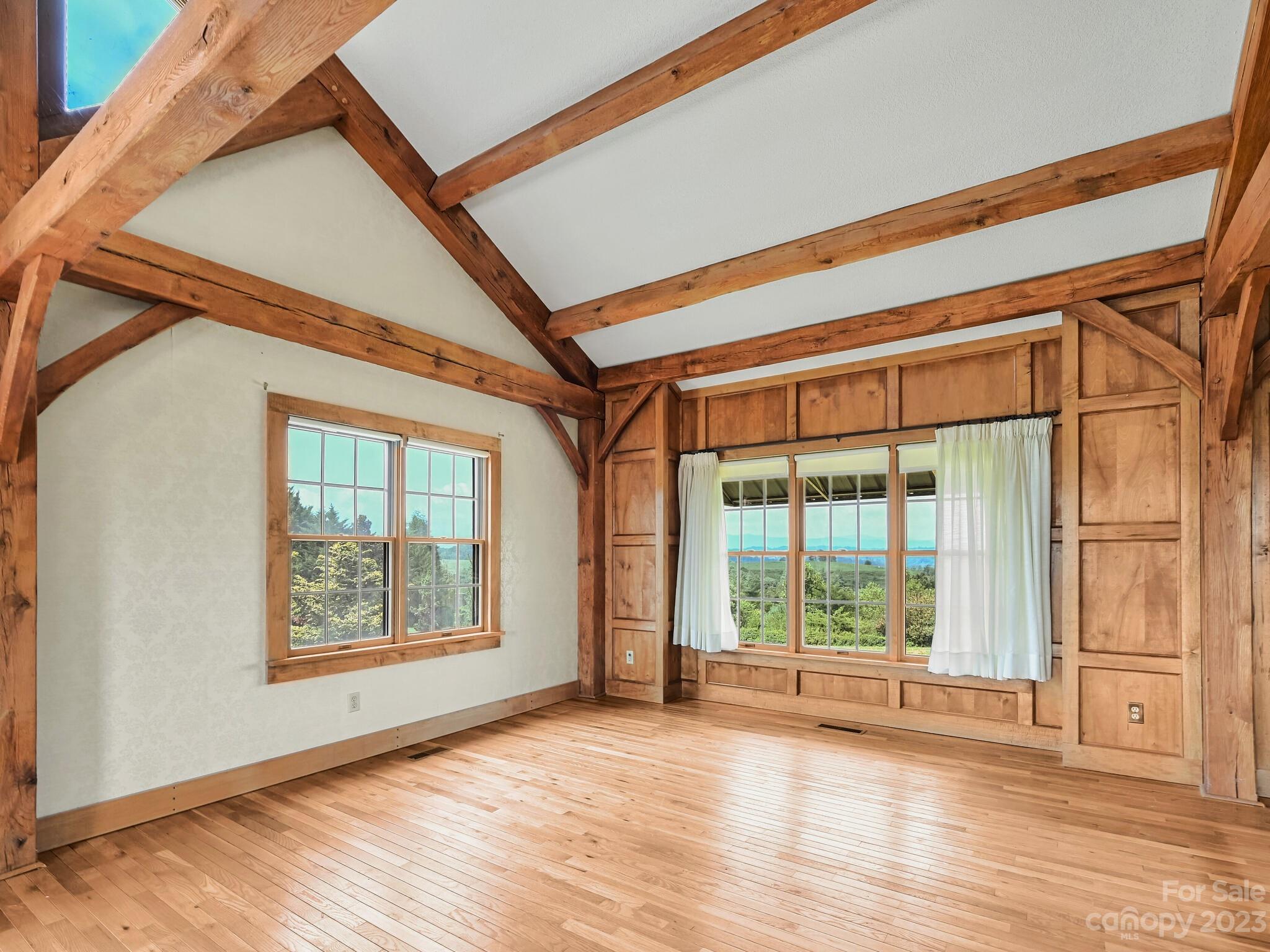 386 Heather Downs Drive Alexander, NC 28701 - Photo 14 of 29 a view of an empty room with wooden floor and windows
