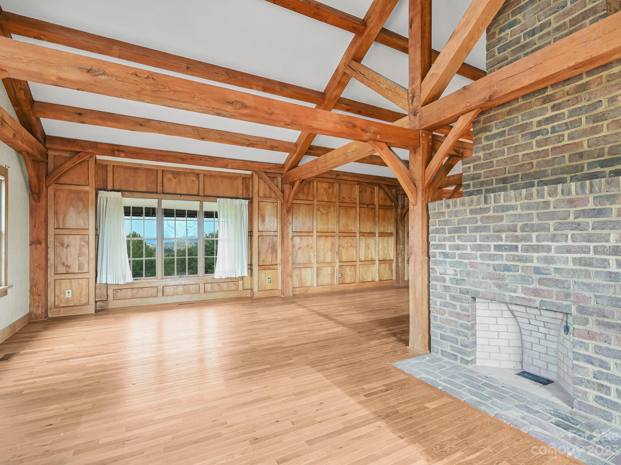 386 Heather Downs Drive Alexander, NC 28701 - Photo 17 of 29 a view of an empty room with wooden floor and a window