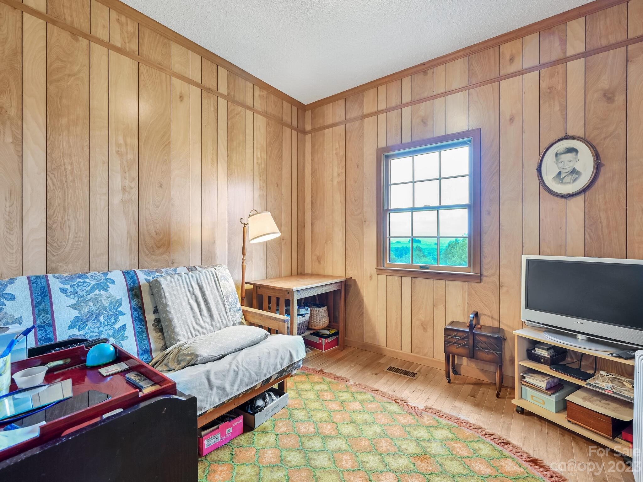386 Heather Downs Drive Alexander, NC 28701 - Photo 20 of 29 a living room with furniture and a flat screen tv