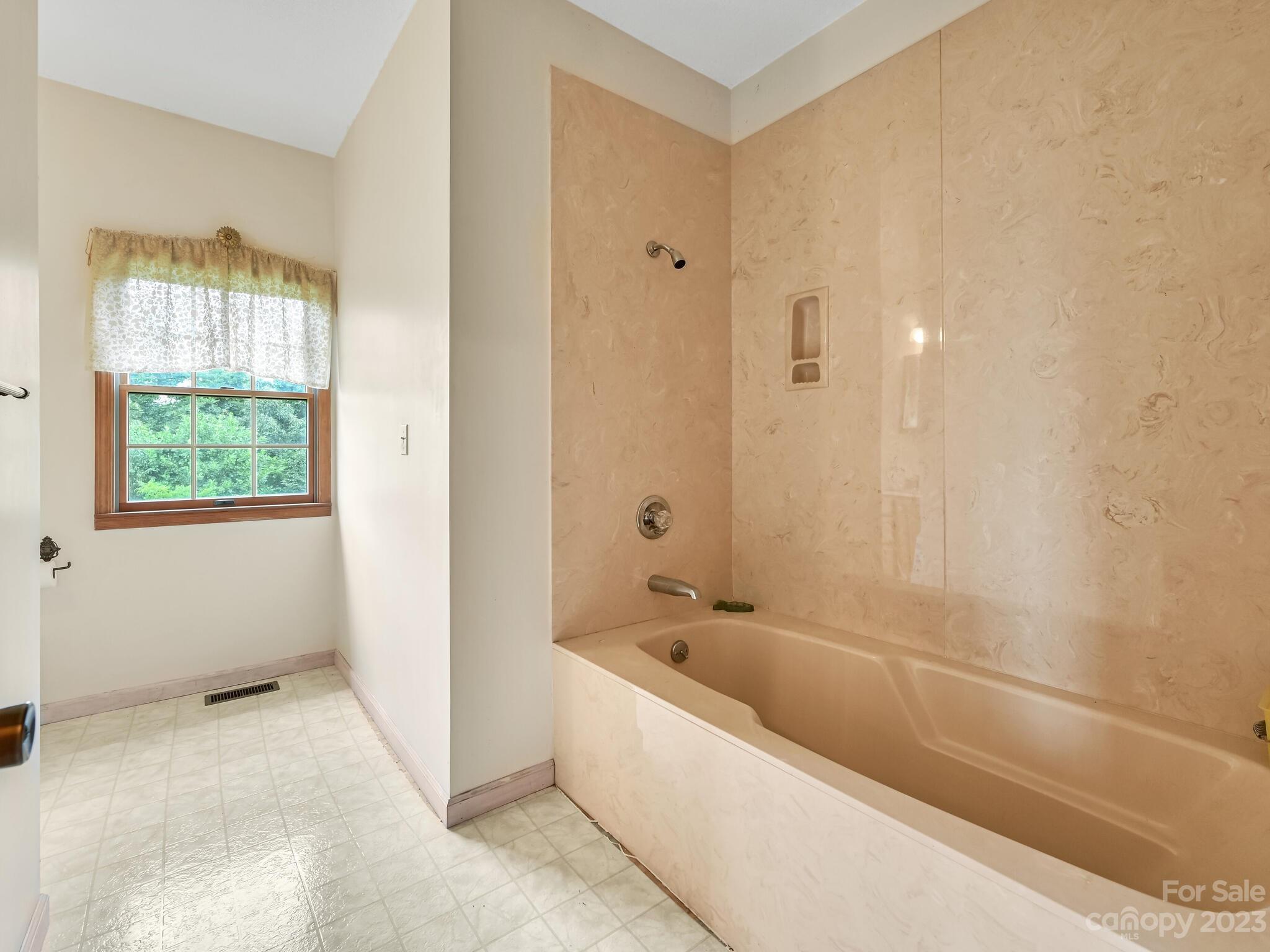 386 Heather Downs Drive Alexander, NC 28701 - Photo 21 of 29 a bathroom with a bathtub and shower