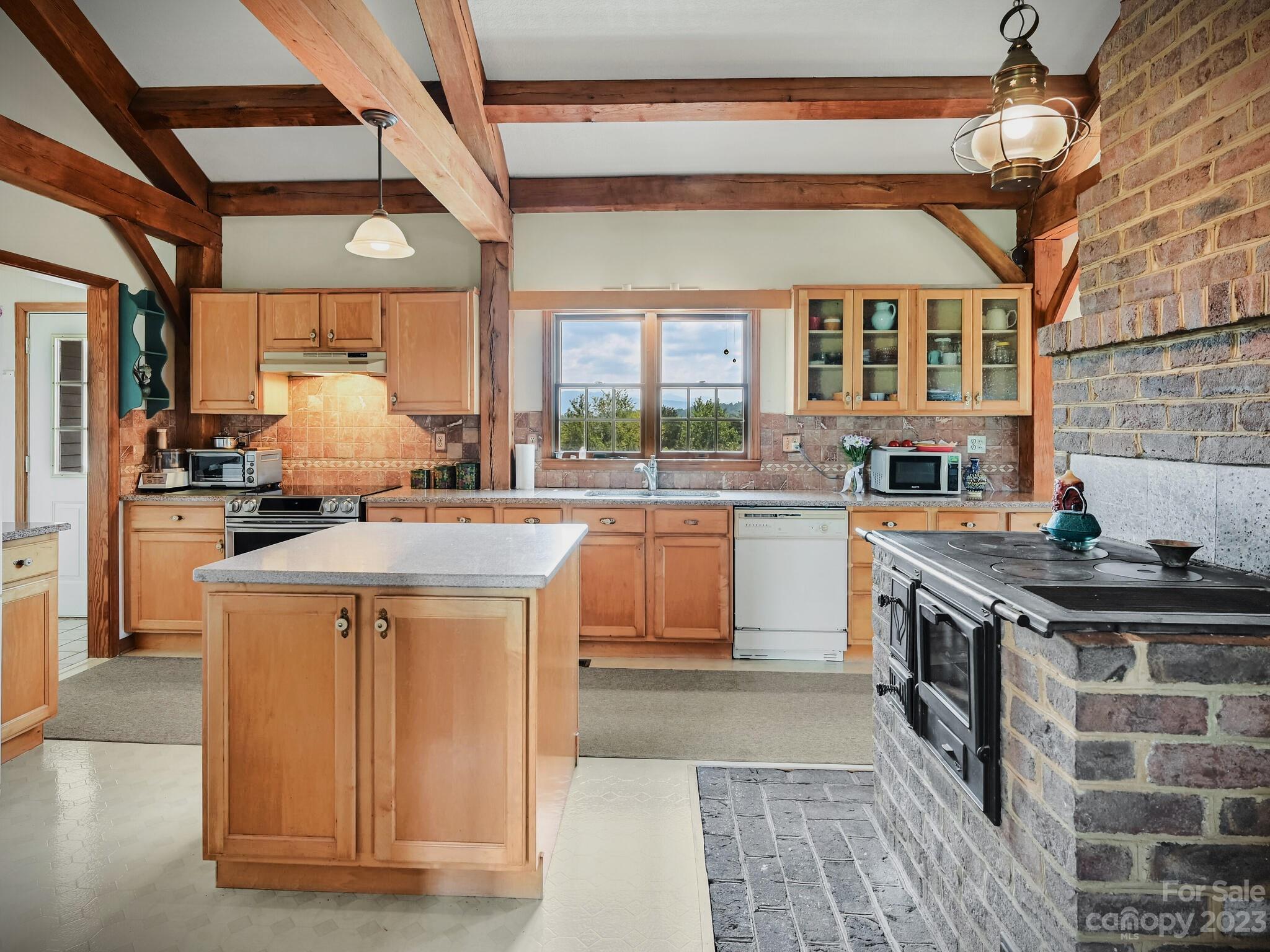386 Heather Downs Drive Alexander, NC 28701 - Photo 6 of 29 a kitchen with a stove and a sink