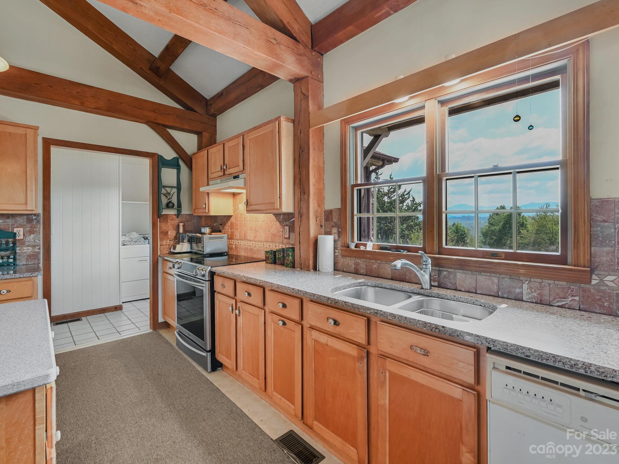 386 Heather Downs Drive Alexander, NC 28701 - Photo 7 of 29 a kitchen with stainless steel appliances granite countertop a sink and a stove