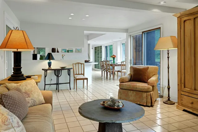 a living room with furniture and a lamp