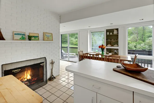 a living room with furniture a fireplace and window