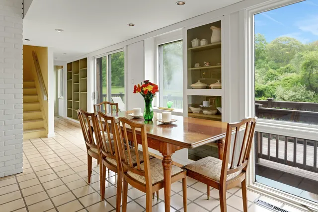a dining room with furniture and window