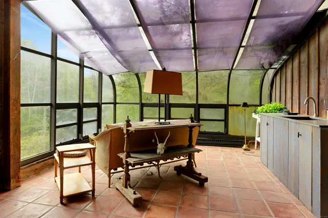 a view of chairs and window in a room