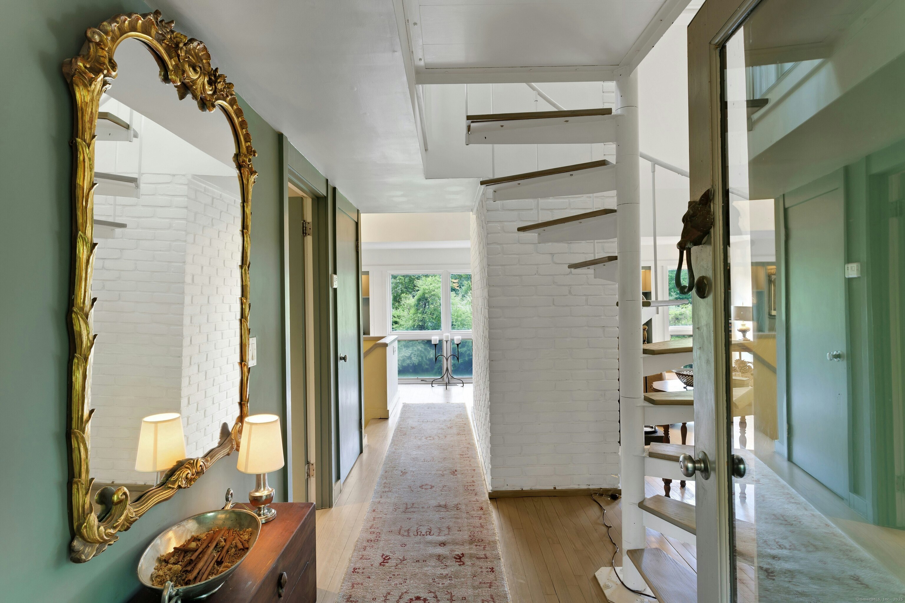 32 Beeholm Road Redding, CT 06896 - Photo 22 of 40 a view of a hallway to a livingroom with furniture