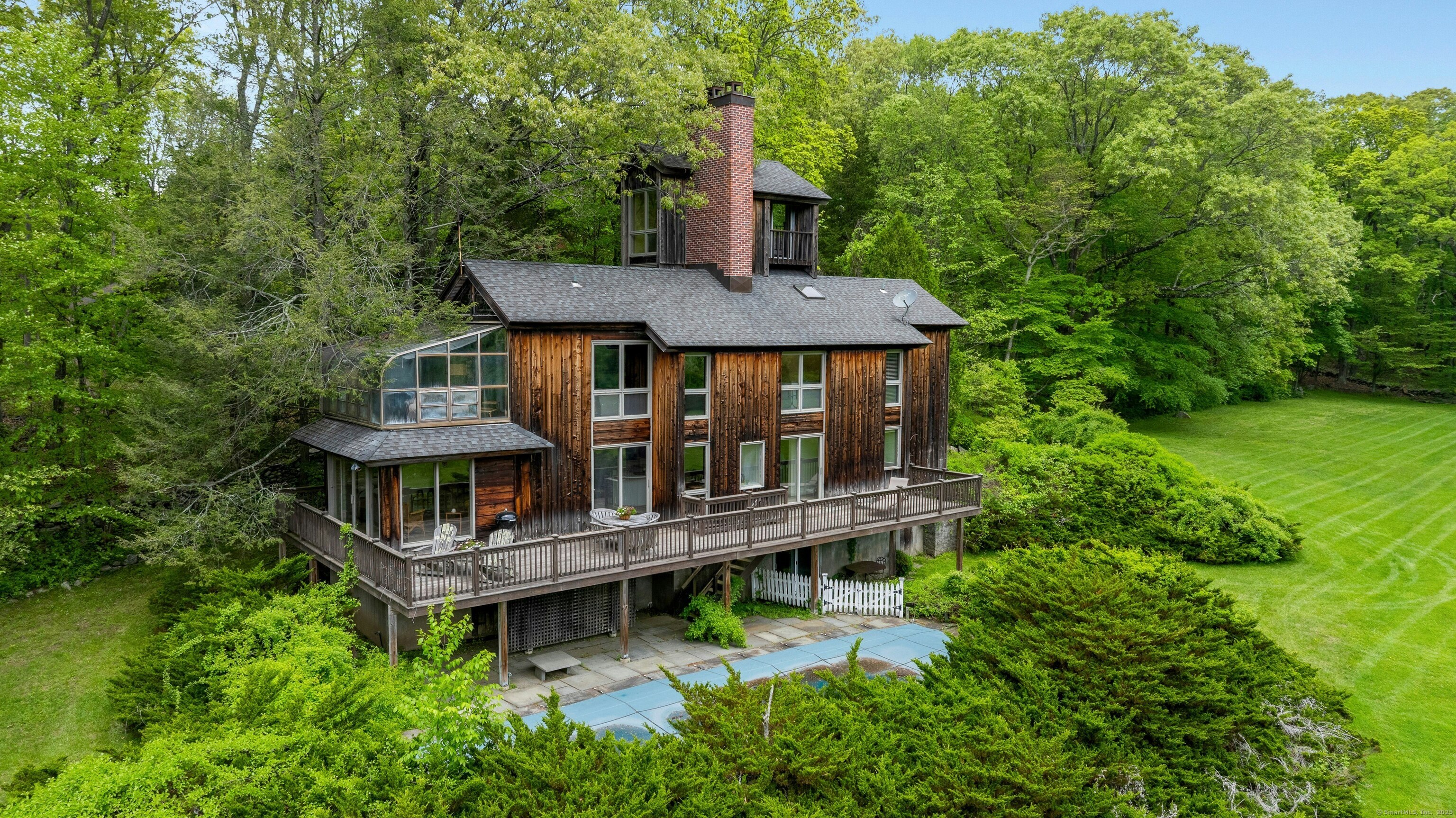 32 Beeholm Road Redding, CT 06896 - Photo 26 of 40 aerial view of a house with balcony and trees al around
