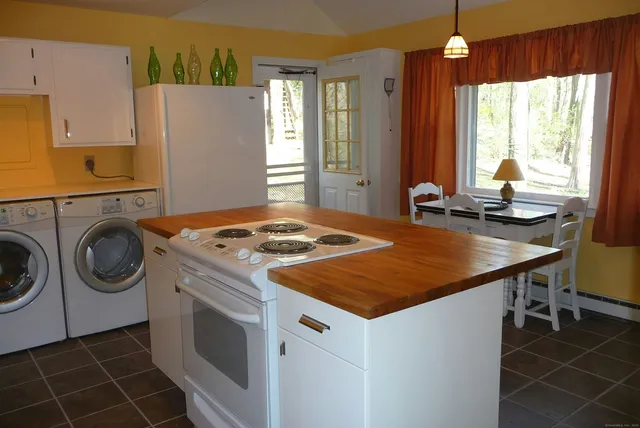 a kitchen that has a stove a sink and a refrigerator