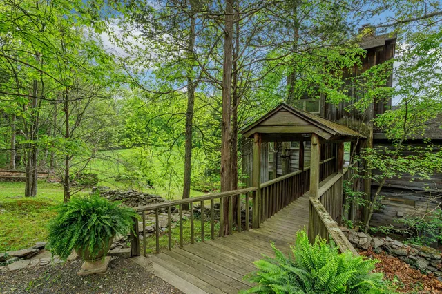 a view of a house with large windows and a small yard