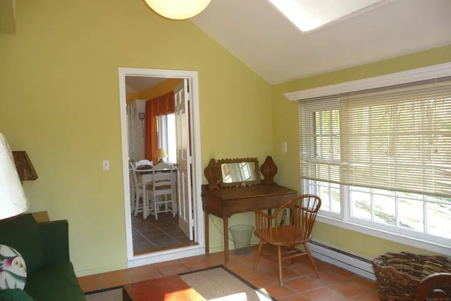 a dining room with furniture and a window