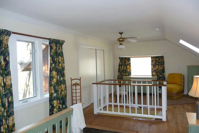 a view of entryway with a window and wooden floor