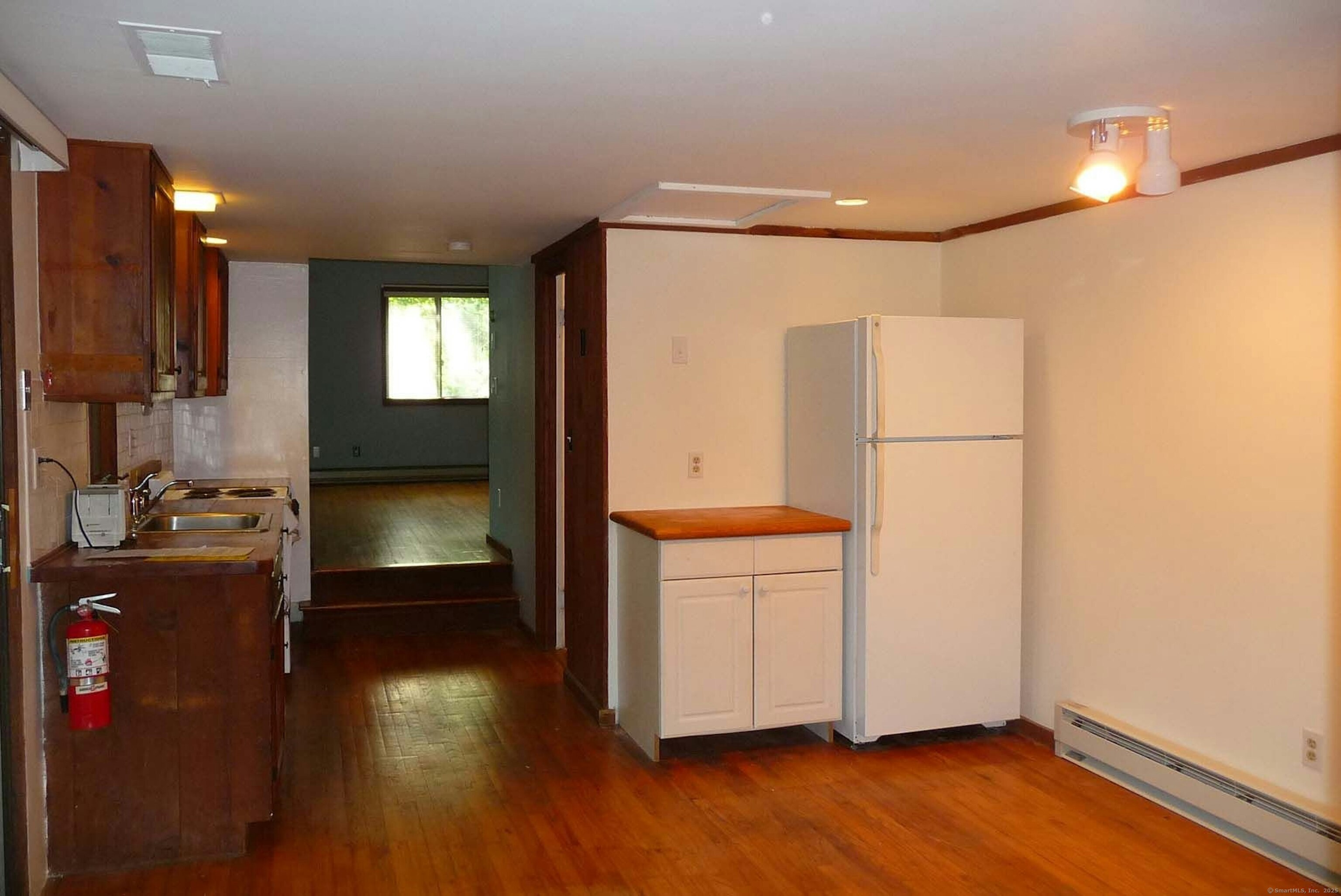 32 Beeholm Road Redding, CT 06896 - Photo 35 of 40 a view of a refrigerator in kitchen and wooden floor