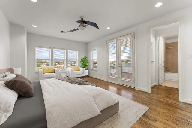 a spacious bedroom with a large bed and a large window