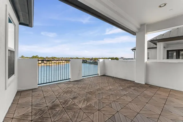 a view of a balcony with wooden floor