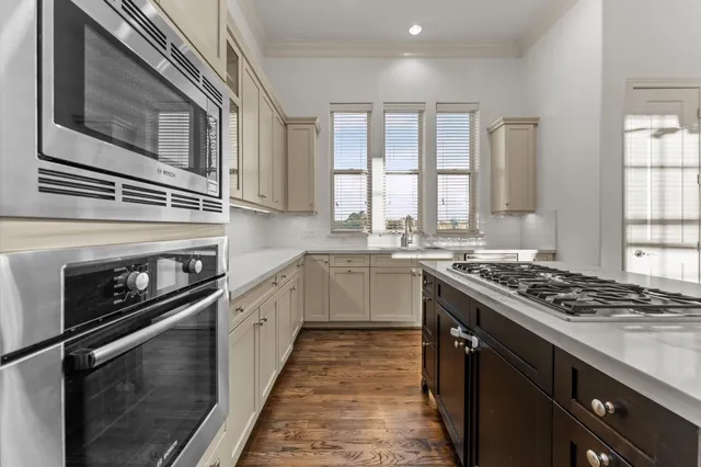 a kitchen with stainless steel appliances granite countertop a stove and a sink