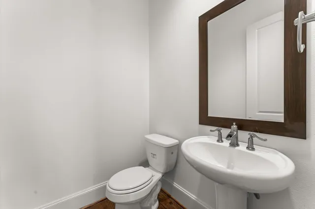 a bathroom with a sink a toilet and mirror