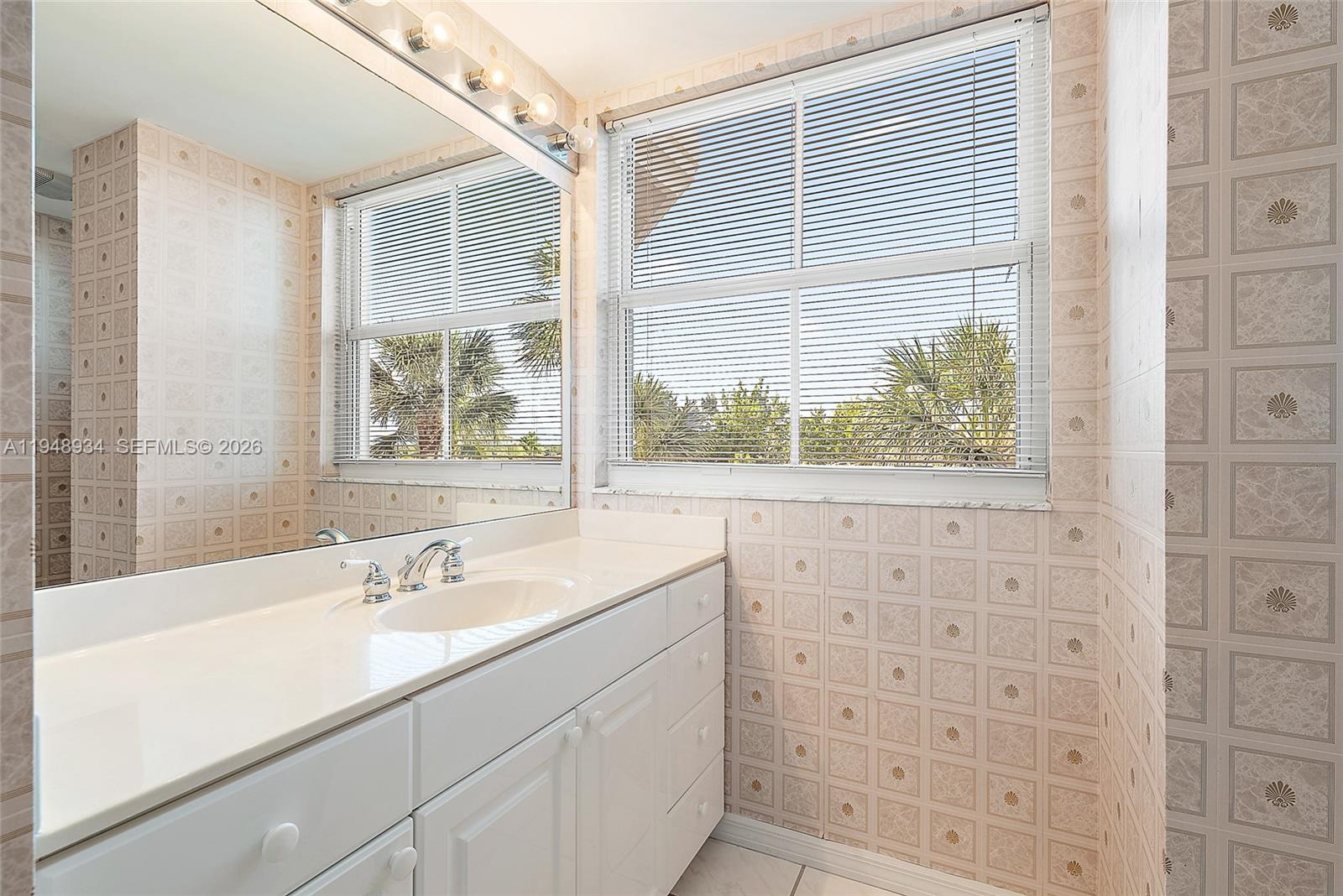 1660 Florida A1A, Unit 222 Jupiter, FL 33477 - Photo 17 of 34 a bathroom with a sink a shower and a mirror
