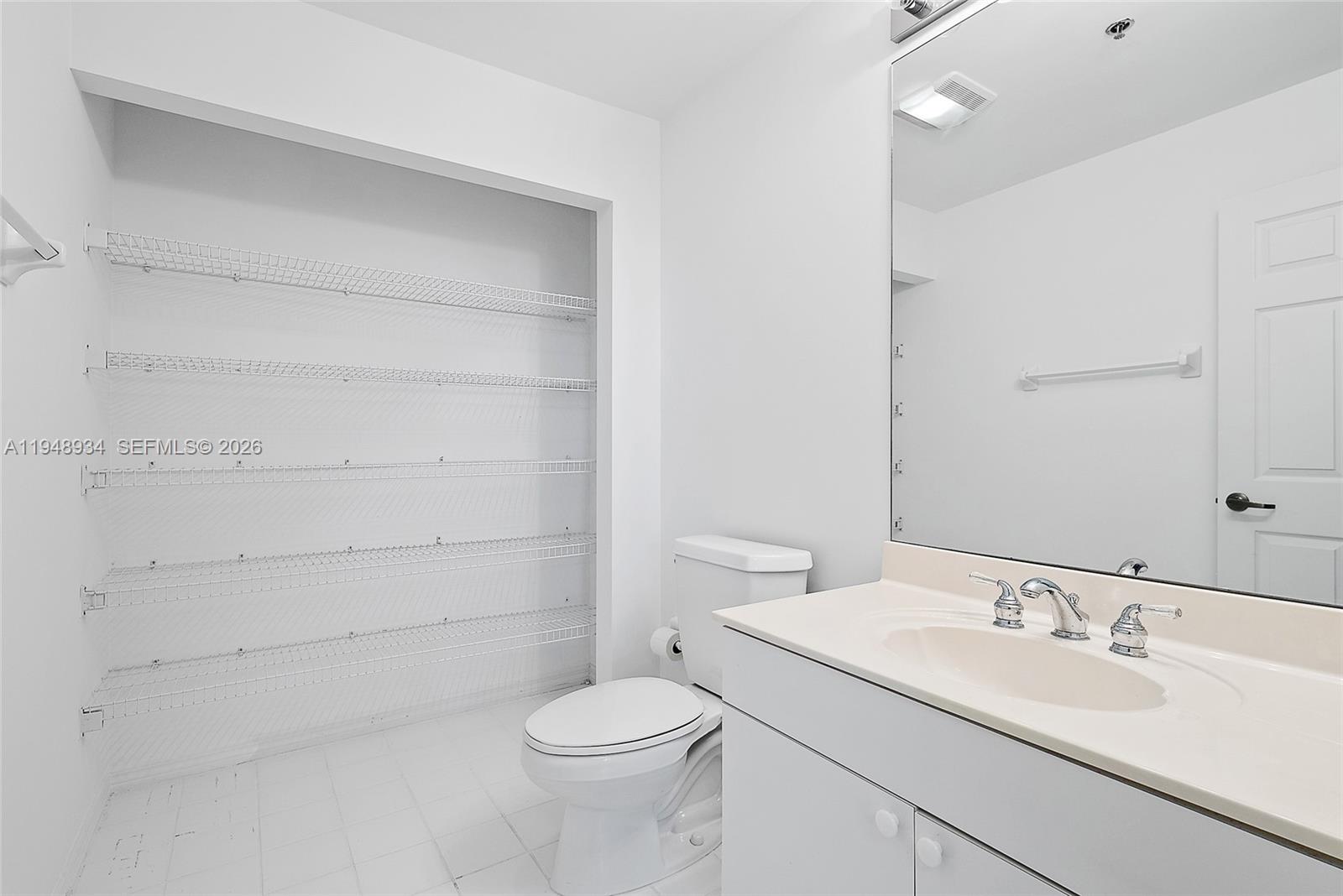 1660 Florida A1A, Unit 222 Jupiter, FL 33477 - Photo 24 of 34 a bathroom with a sink a toilet and vanity