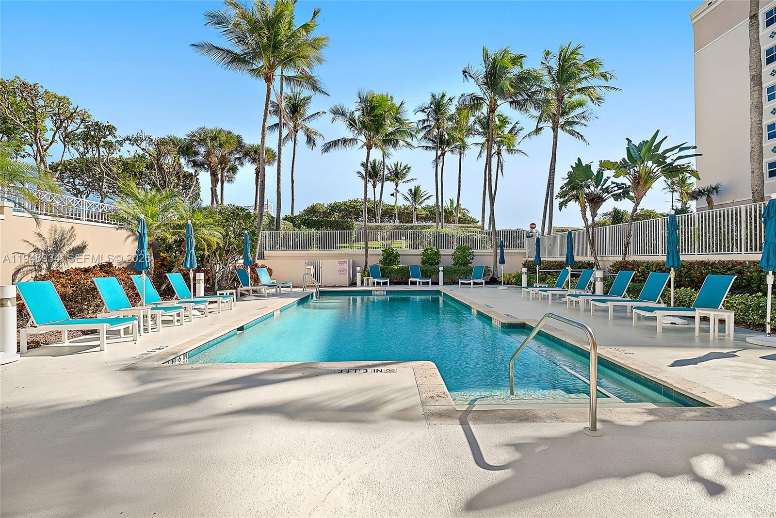 1660 Florida A1A, Unit 222 Jupiter, FL 33477 - Photo 28 of 34 a swimming pool with outdoor seating and a garden