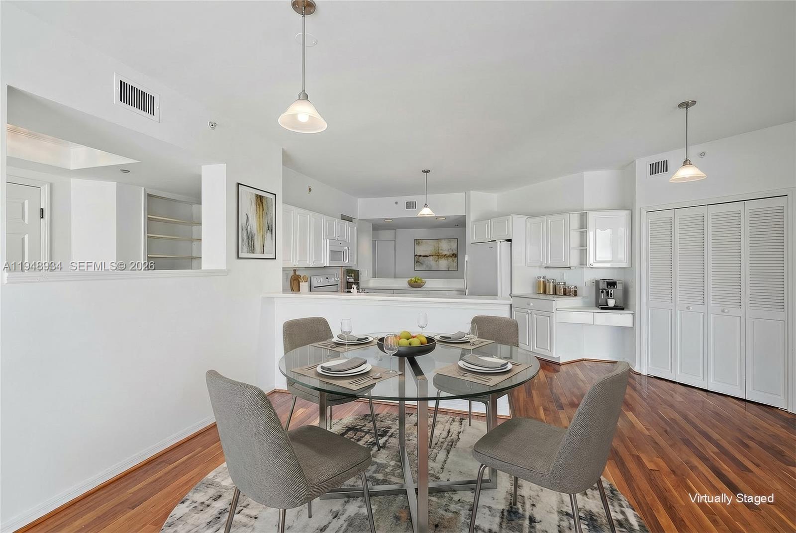 1660 Florida A1A, Unit 222 Jupiter, FL 33477 - Photo 9 of 34 a view of a dining room with furniture and wooden floor
