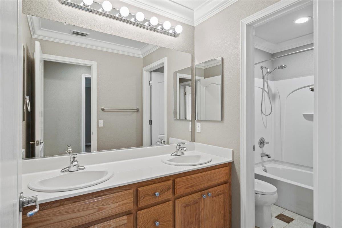 4056 Aitken Dairy Road Rocklin, CA 95677 - Photo 47 of 59 a bathroom with a granite countertop sink toilet a large mirror a shower and a mirror