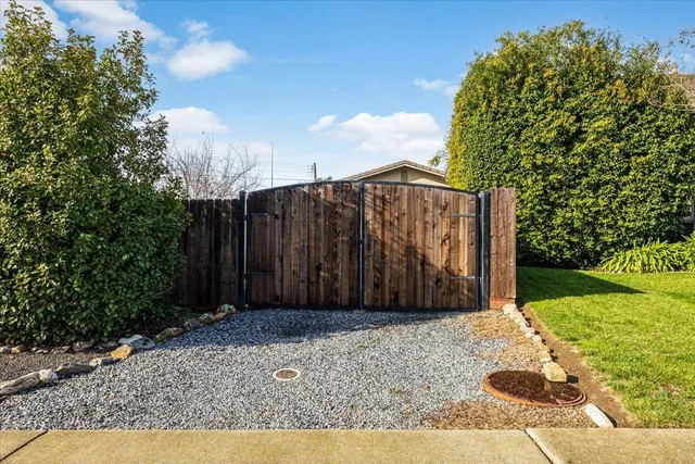 a view of a house with a patio and a yard