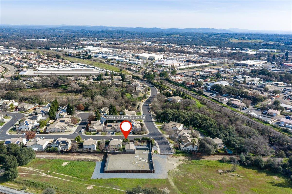 4056 Aitken Dairy Road Rocklin, CA 95677 - Photo 57 of 59 an aerial view of a house with a swimming pool and mountains