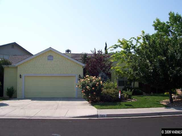780 Putnam Drive Reno, NV 89503 - Photo 1 of 8 a front view of a house with a garden and trees