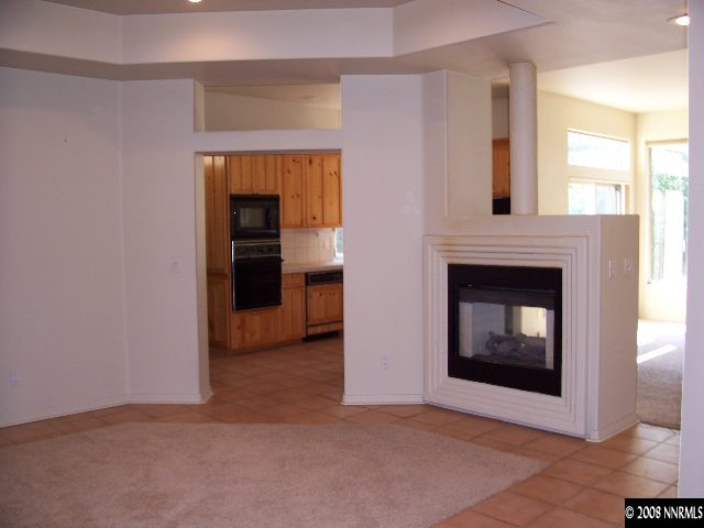 780 Putnam Drive Reno, NV 89503 - Photo 2 of 8 a view of an empty room with fire place and a window