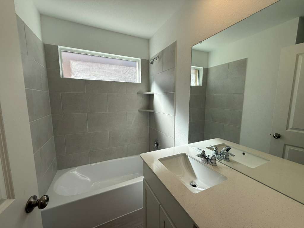 577 Sormonne Loop Kyle, TX 78640 - Photo 15 of 39 a bathroom with a sink and a mirror