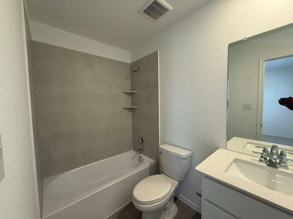 577 Sormonne Loop Kyle, TX 78640 - Photo 18 of 39 a bathroom with a sink a toilet and a mirror