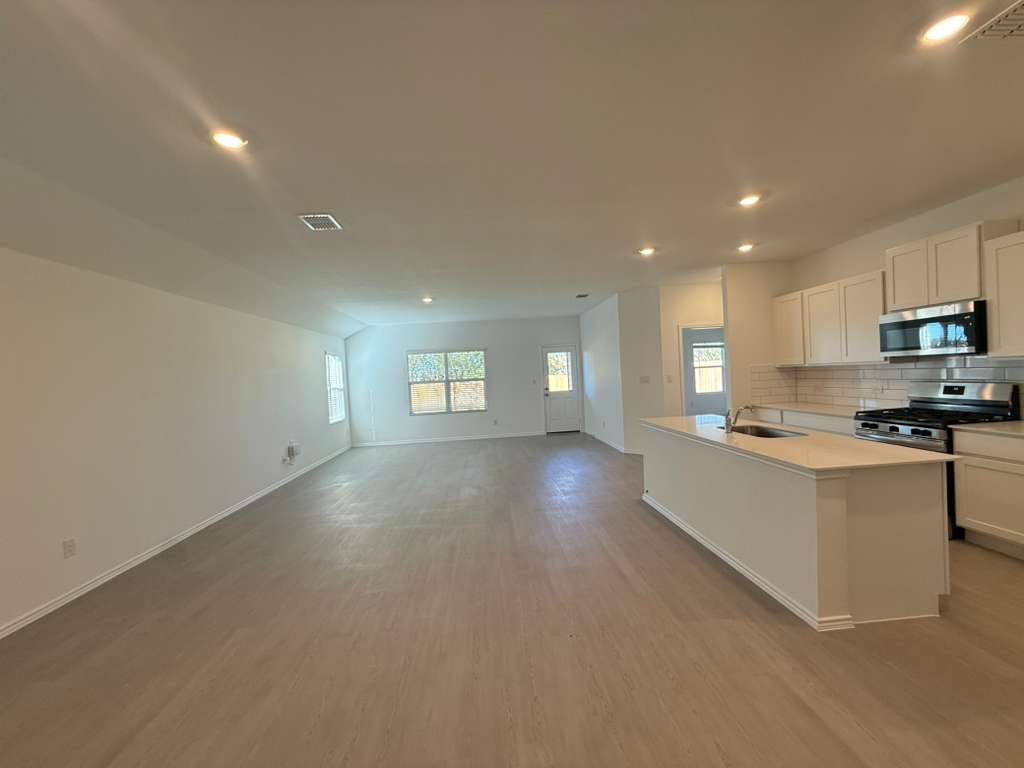 577 Sormonne Loop Kyle, TX 78640 - Photo 38 of 39 a view of kitchen with sink microwave and cabinets