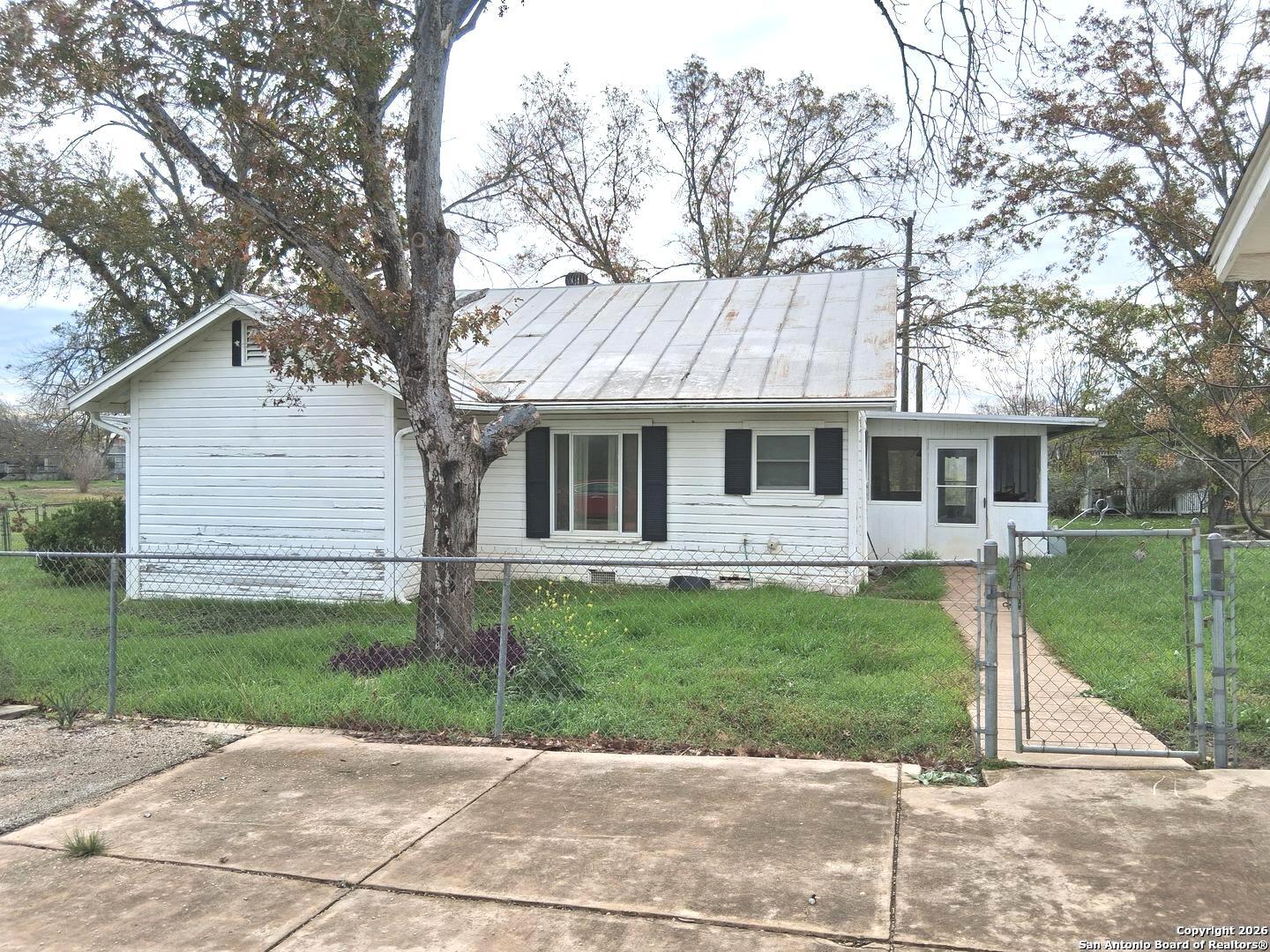 7431-7433 Real Road China Grove, TX 78263 - Photo 4 of 17 a front view of a house with a yard