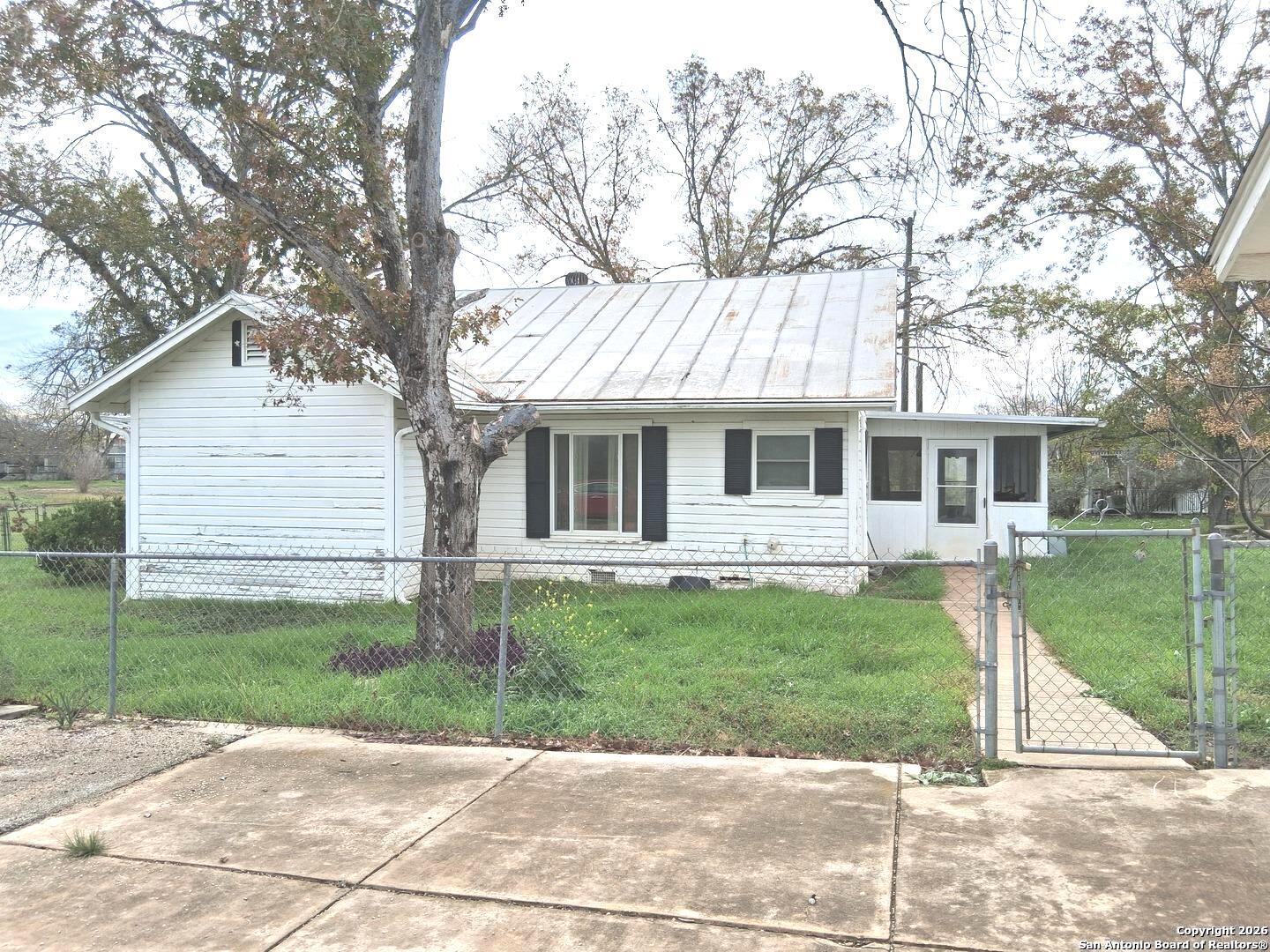 7431-7433 Real Road China Grove, TX 78263 - Photo 7 of 17 a front view of a house with a yard