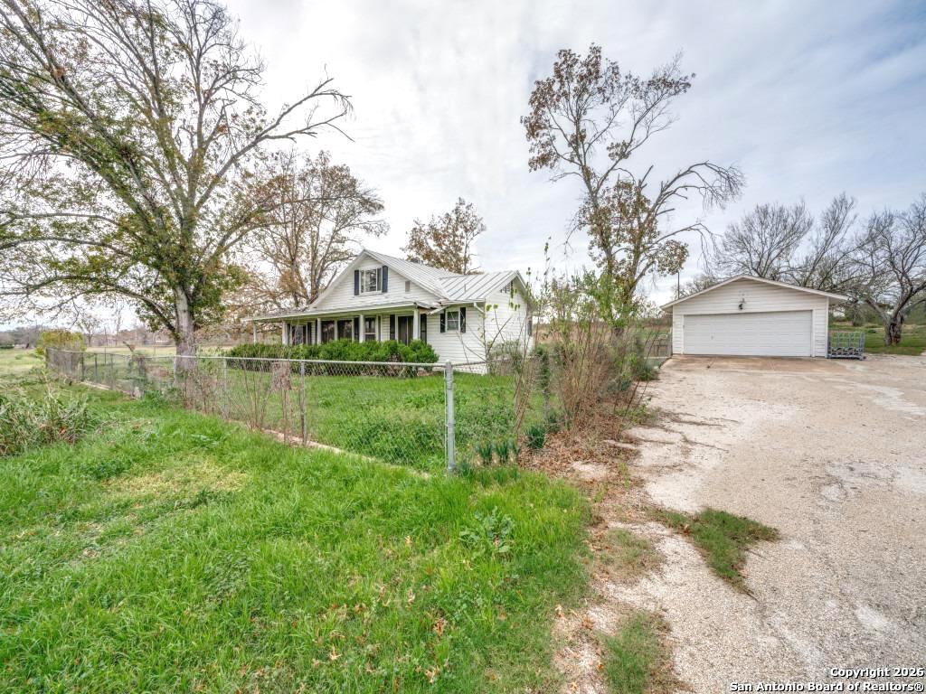 7431-7433 Real Road China Grove, TX 78263 - Photo 8 of 17 a front view of a house with garden