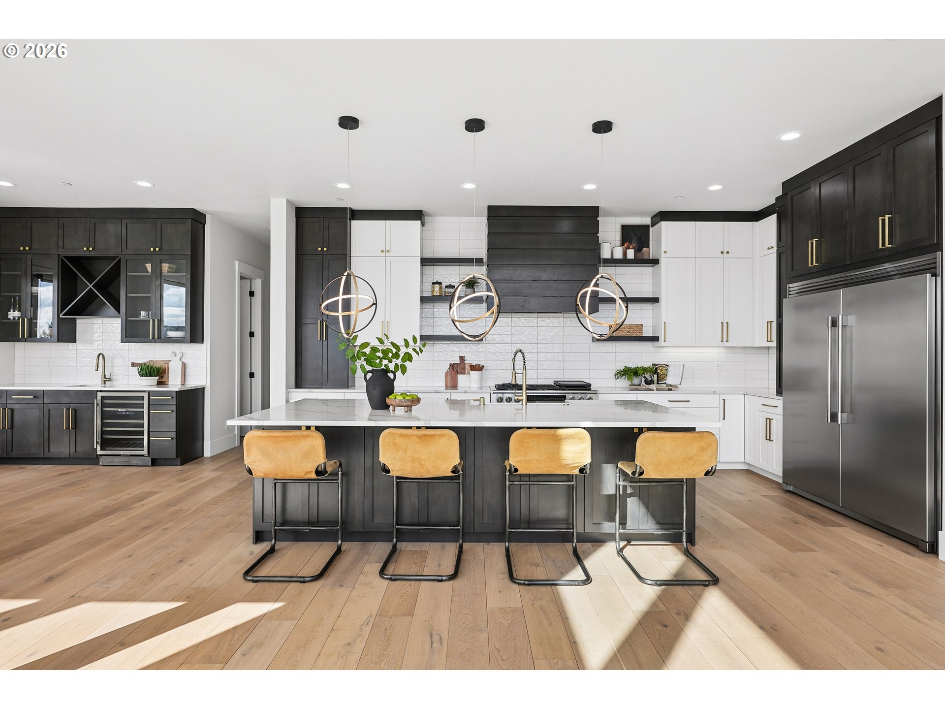 1757 North Columbia Ridge Way Washougal, WA 98671 - Photo 12 of 48 a kitchen with stainless steel appliances kitchen island granite countertop a dining table chairs and a refrigerator