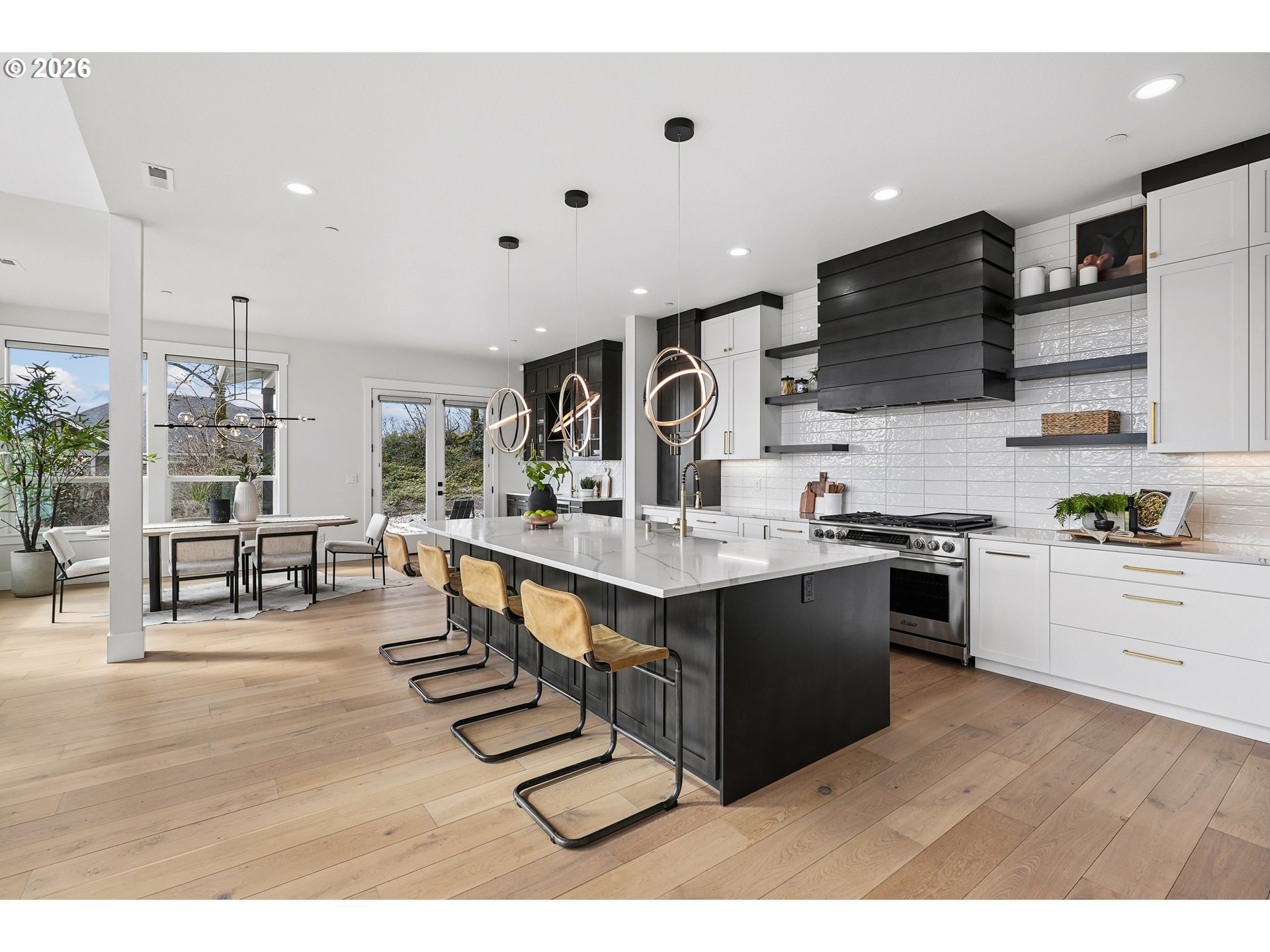 1757 North Columbia Ridge Way Washougal, WA 98671 - Photo 15 of 48 a kitchen with stainless steel appliances kitchen island granite countertop a table chairs sink and cabinets