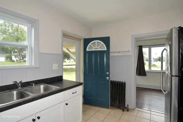 a kitchen with a sink and a refrigerator