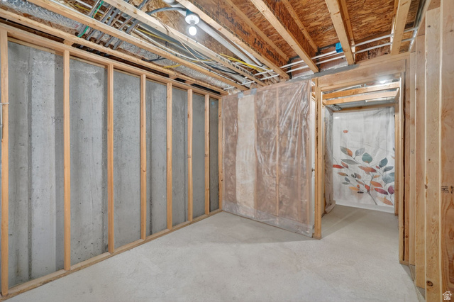 295 Spruce Way Santaquin, UT 84655 - Photo 24 of 32 Unfinished basement featuring concrete flooring, exposed wood framing, and an exposed ceiling with visible utilities
